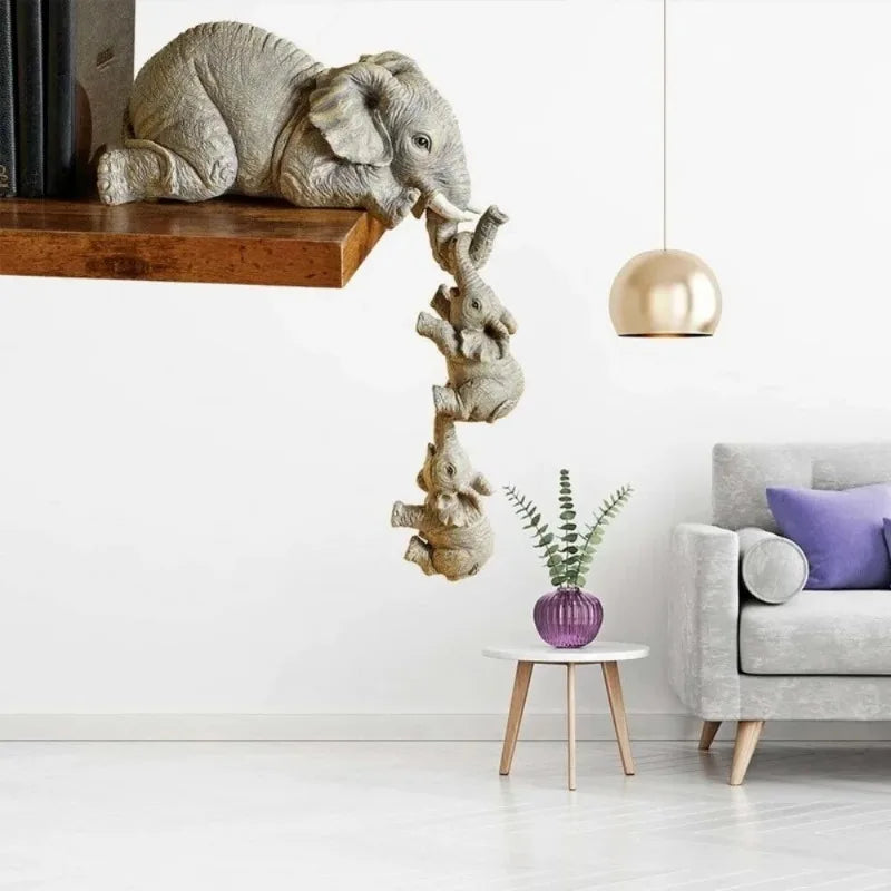 Kit com 3 estatuetas decorativas de elefantes em resina abraçando filhotes para decoração de ambientes internos